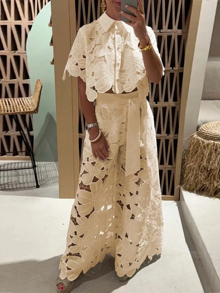 Chic women's floral matching set: cropped top & wide leg pants. Stylish summer outfit for casual or party wear.