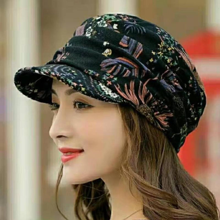 Close-up of a women's floral pleated cap showcasing intricate pleats and vibrant flower pattern.