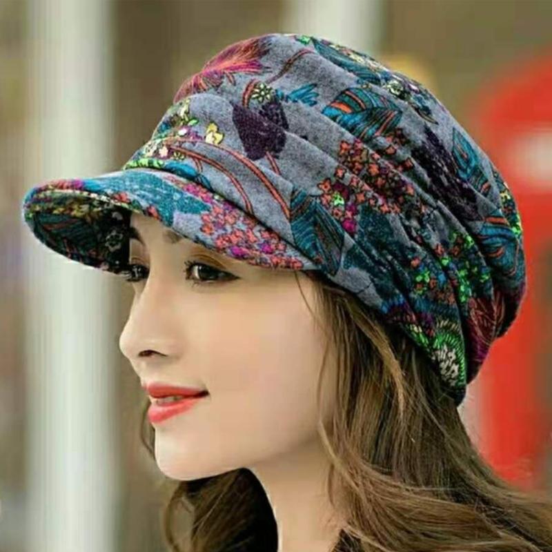 Side profile of a women's floral pleated short brim cap, an elegant winter fashion headwear accessory.