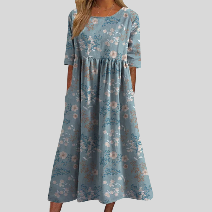 Breezy summer floral midi dress with an empire waist, perfect for casual outings or elegant gatherings.