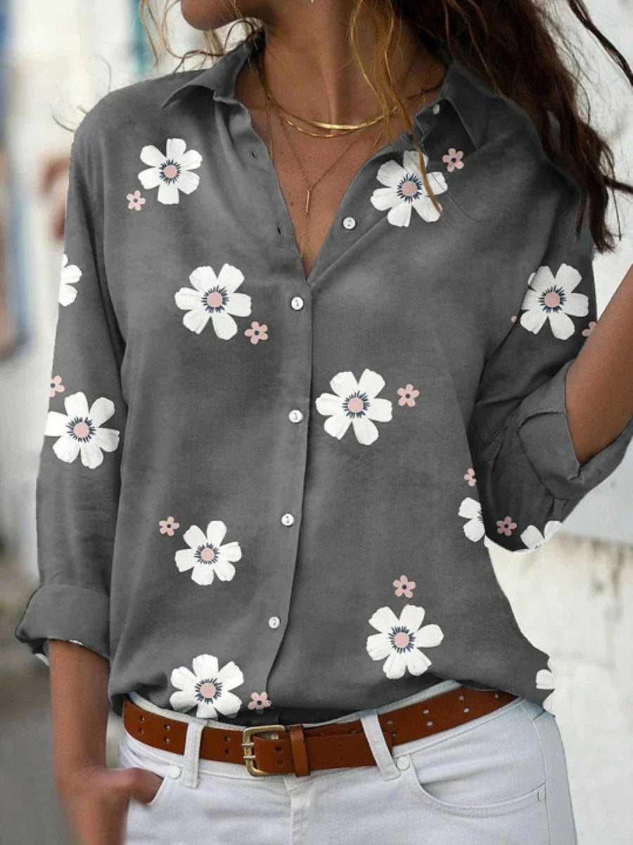 Stylish pink floral print button front blouse for women. Long sleeve collared casual top, ideal for spring fashion.