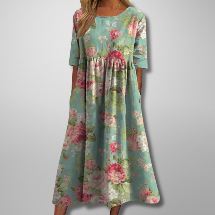 Comfortable loose-fit women's midi dress with vibrant floral print, short sleeves, & round neck for summer style.
