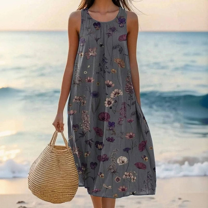 Relaxed fit women's floral midi dress featuring a scoop neck, sleeveless style, and convenient pockets.