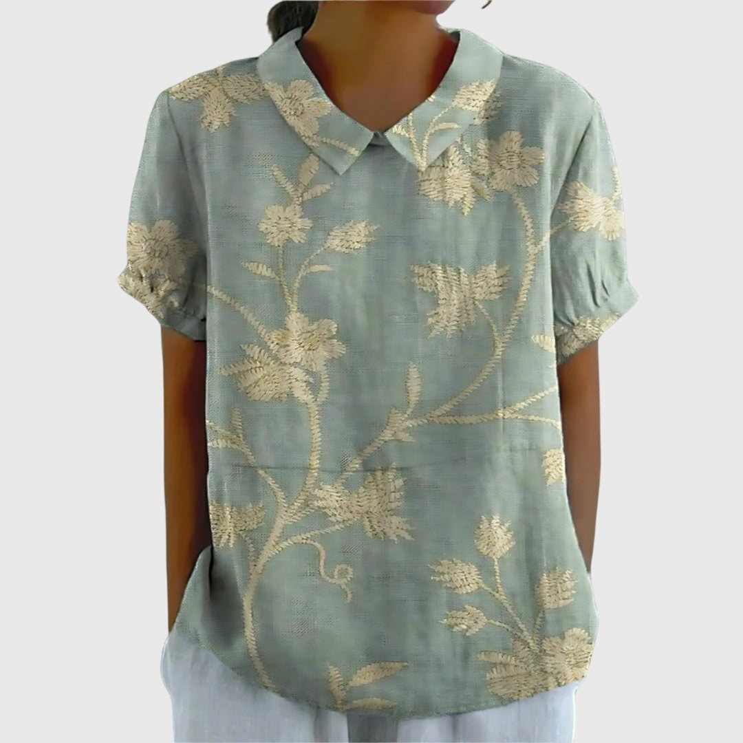 Relaxed fit women's floral short sleeve blouse with a collared design, offering ultimate comfort for summer days.