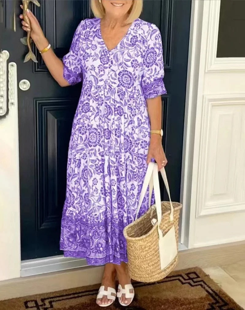 Vibrant floral print women's V-neck A-line dress, a stylish midi length for spring and summer casual elegance.