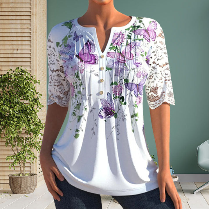Close-up of a polyester women's blouse featuring a vibrant floral print and button details