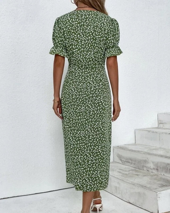 Close-up of the V-neck and floral print on a women's flowy maxi summer dress.