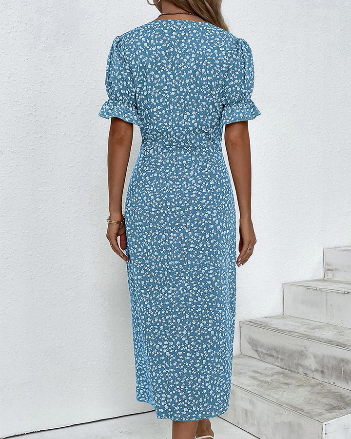 Back view of a women's elegant floral V-neck flowy maxi summer dress.
