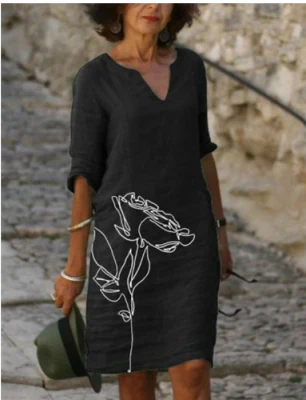 Elegant women's midi dress featuring a vibrant floral pattern and unique artistic face print