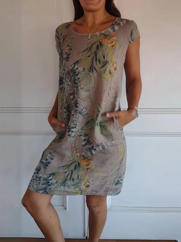 Elegant patterned dress for women. Loose fit, round neck, and vibrant print for stylish summer fashion.