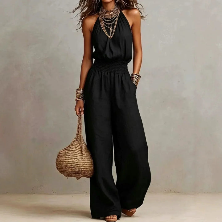 Flowing wide leg halter jumpsuit for women, a comfortable and chic summer outfit for vacation or casual wear.