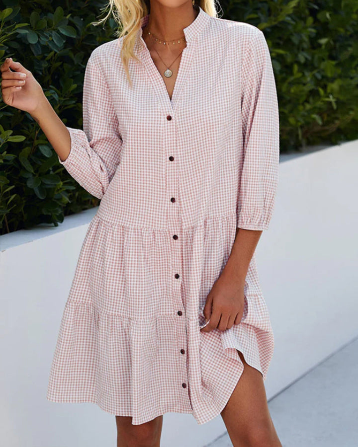 Modern women's flowy A-line summer dress featuring a distinct check pattern and a comfortable midi length.