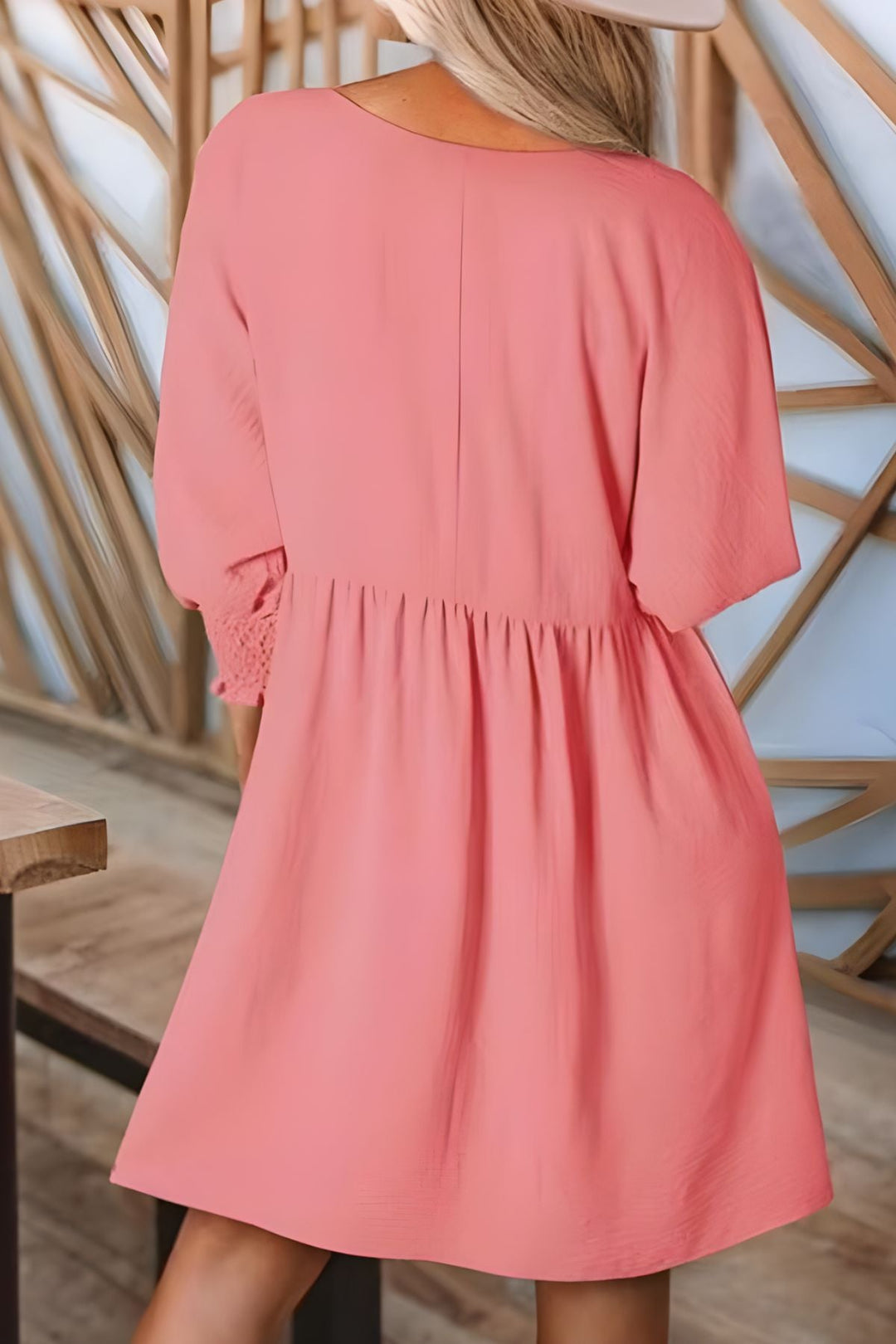 Women's elegant flowy babydoll mini dress with smocked cuffs. Ideal for warm weather, casual chic style.