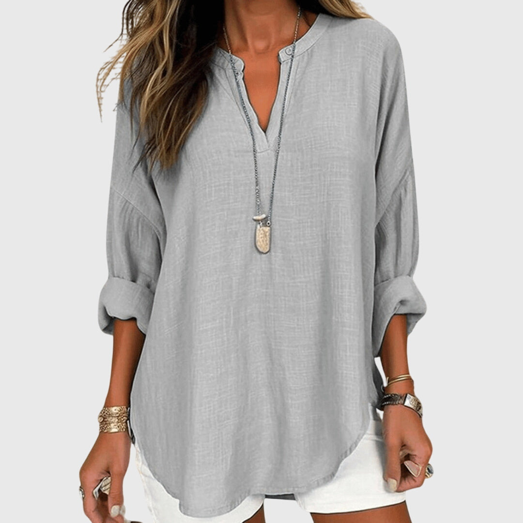 Loose fit women's flowy long sleeve beach shirt, an elegant top for comfortable summer beachwear.