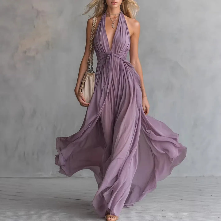 Women's flowy evening maxi dress with pleated halter neckline and elegant backless design, perfect for formal events.