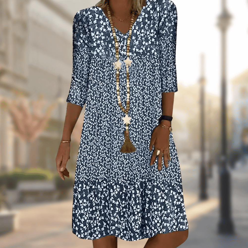 Women's flowy floral print tiered summer dress with V-neck & three-quarter sleeves, perfect for casual wear.