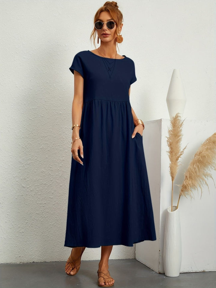 Elegant back view of a women's short sleeve flowy maxi dress, showcasing the loose fit for casual comfort.