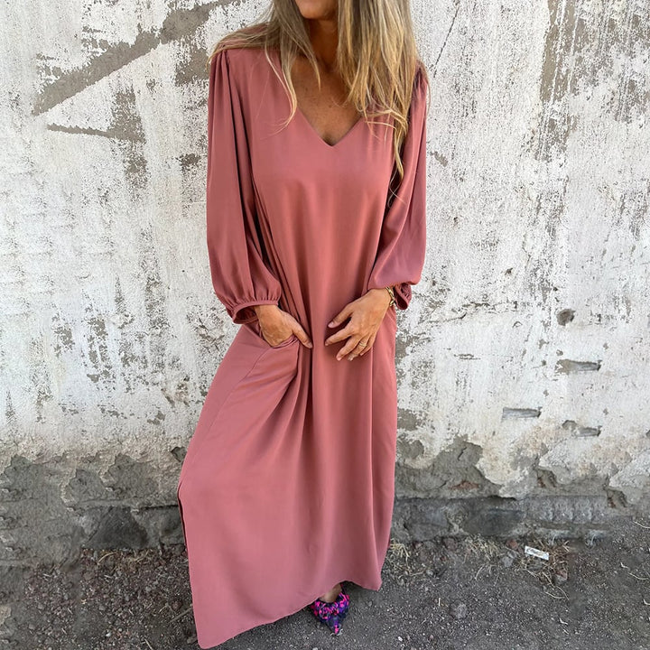 V-neck flowy maxi dress for women featuring chic balloon sleeves and convenient side pockets. Versatile and stylish.