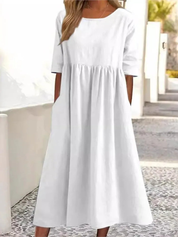 Soft, comfortable women's flowy midi dress. Features a classic round neck & short sleeves, perfect for summer casual.