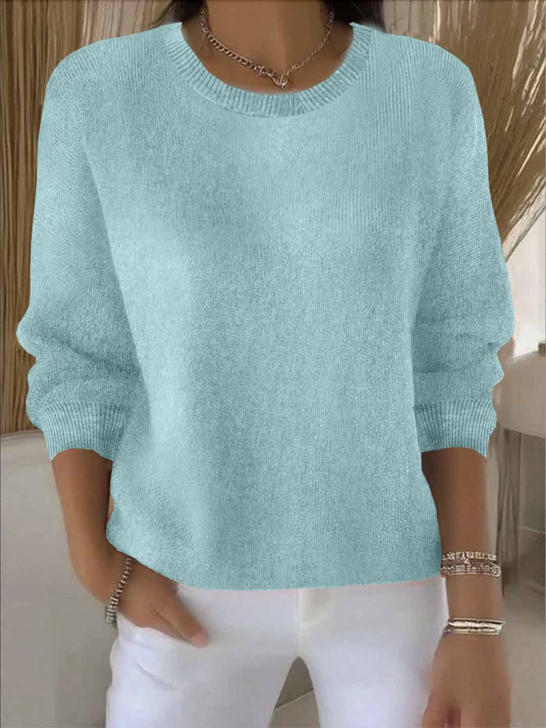 Close-up of soft knit on a women's flowy relaxed fit sweater, offering chic comfort and style.