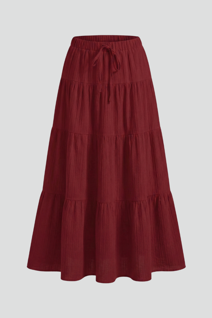 Women's flowy tiered maxi skirt with comfy elastic waist. Versatile for casual or elegant summer fashion.