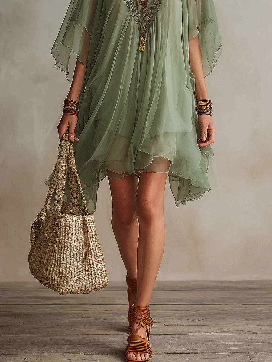 Lightweight women's flowy V-neck tiered mini dress for effortless summer style; a perfect beach outfit.