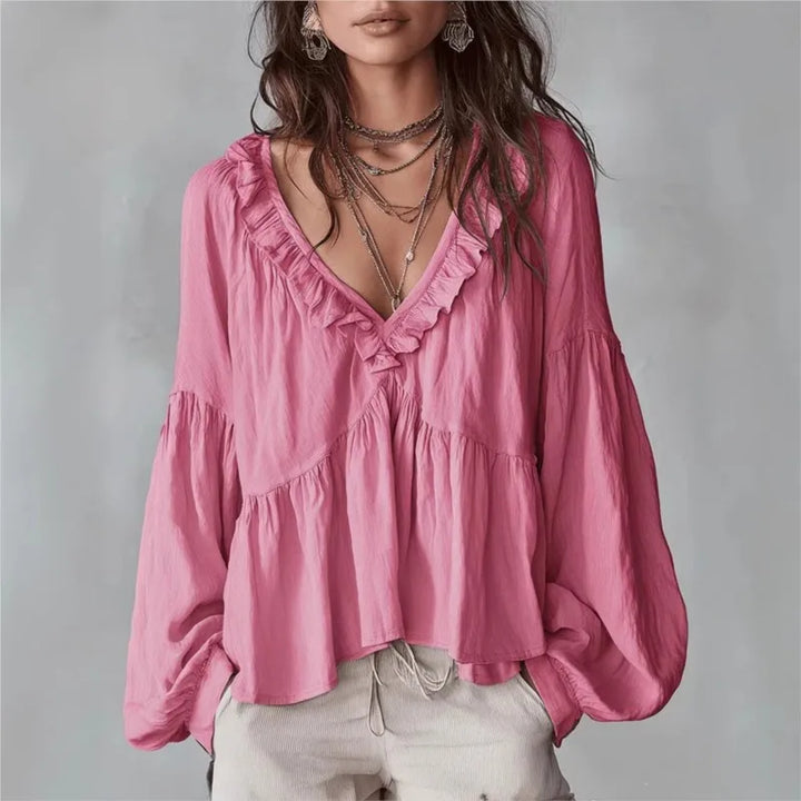 Contemporary women's V-neck ruffle blouse featuring puff sleeves, a flowy top ideal for elegant spring fashion.