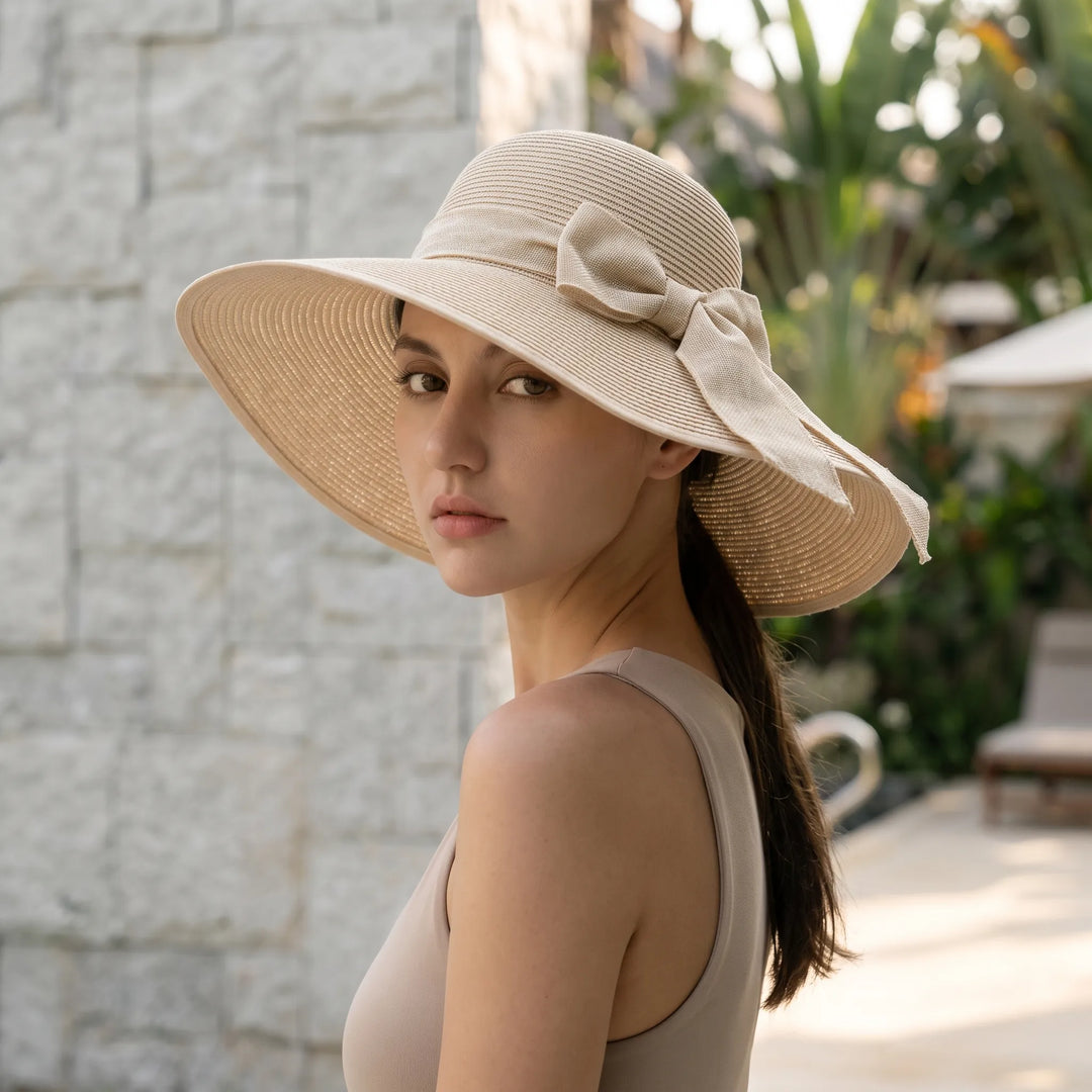 Women's foldable wide brim sun hat for travel, perfect beach vacation essential & summer style accessory.