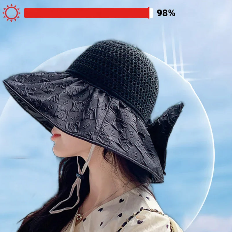 Close-up of a women's foldable wide-brim sun hat texture, showing the papyrus weave and bow.