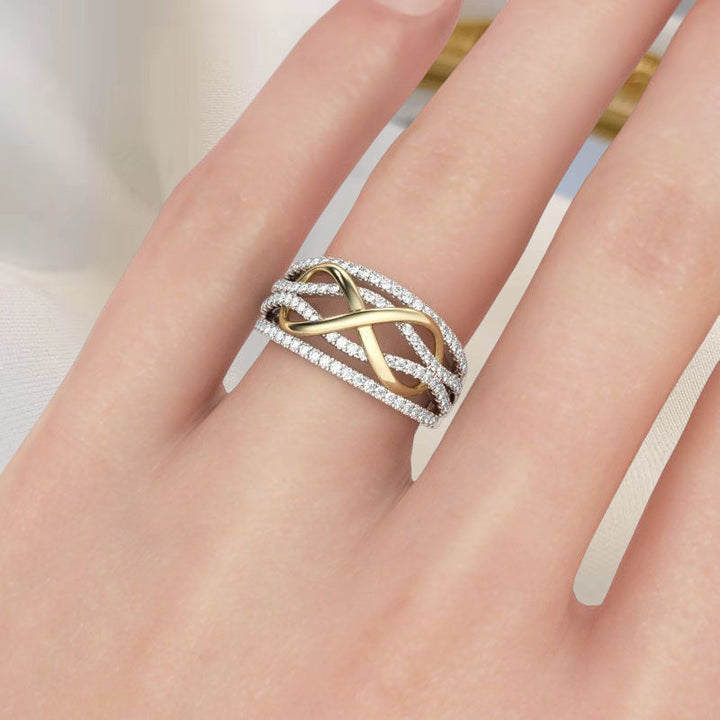 View of a women's silver alloy 'Forever Linked' mother daughter ring, with a sparkling gemstone accent