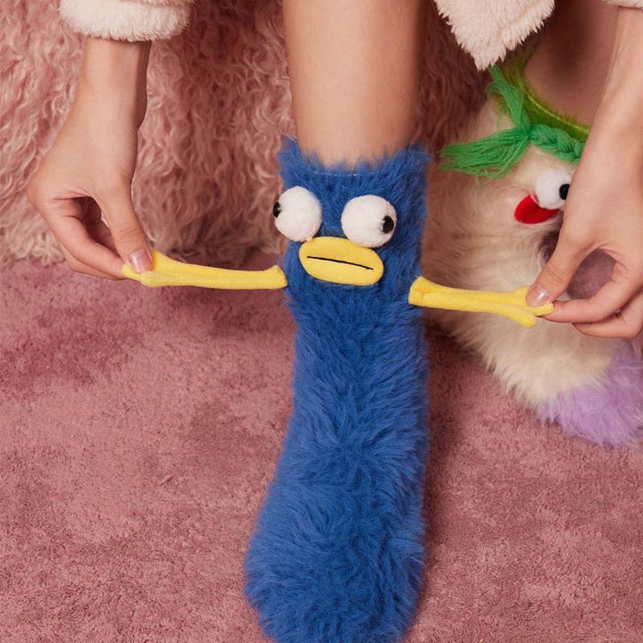 Pair of colorful coral velvet cozy socks with playful 3D cartoon design
