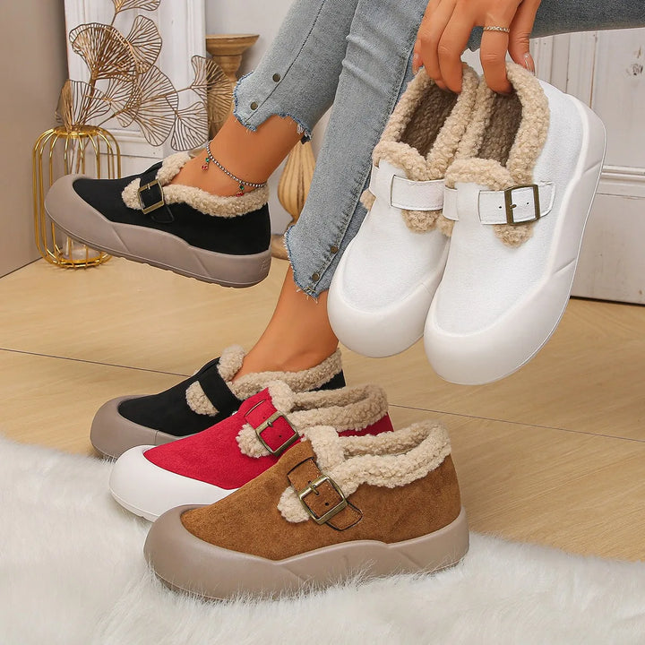 Side view of a women's winter clog, showcasing the durable leather and plush fleece lining.