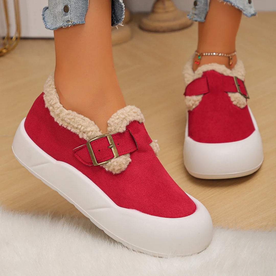 Top-down view of women's slip-on leather clogs, highlighting the fleece lining and buckle closure.