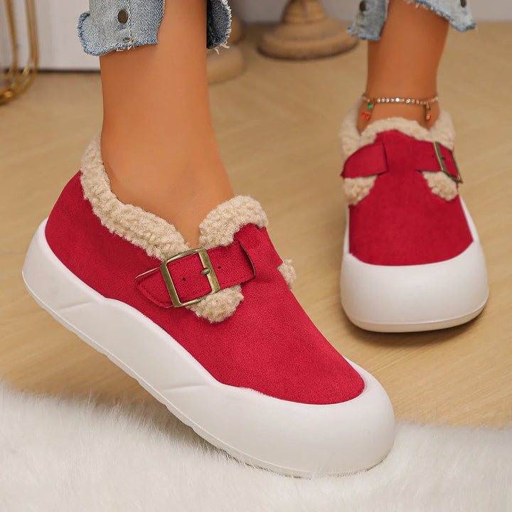 Top-down view of women's slip-on leather clogs, highlighting the fleece lining and buckle closure.