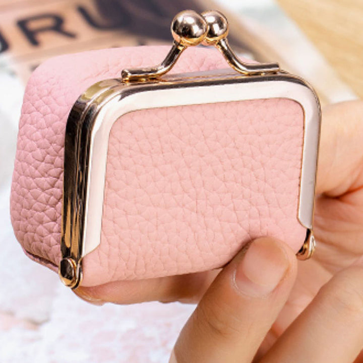 Elegant genuine leather mini jewelry box, a portable organizer for women's rings, earrings, and fashion accessories.