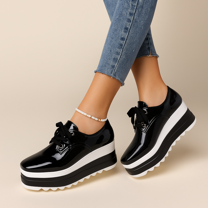 Close-up of the glossy finish on women's platform sneakers, highlighting texture and fashion details.