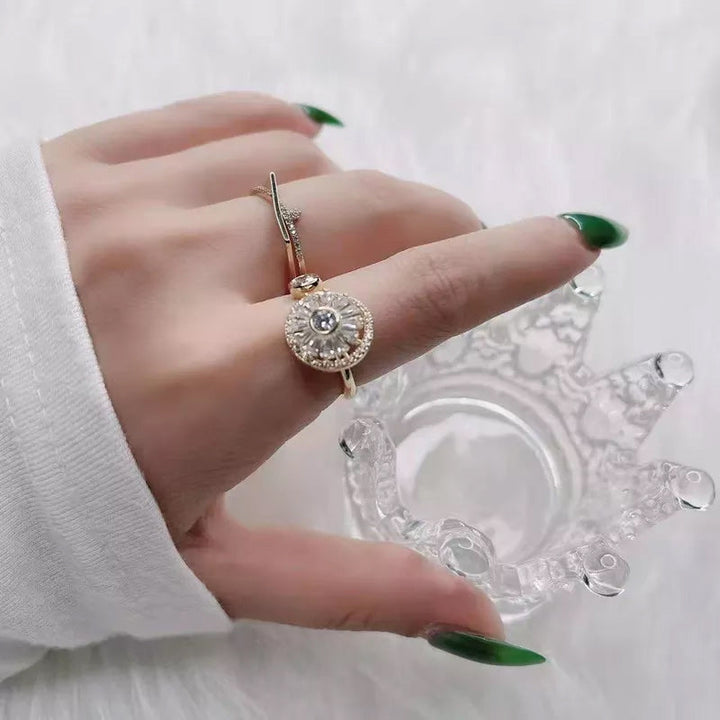 Detailed shot of the spinning mechanism on a women's crystal gold anxiety relief ring.