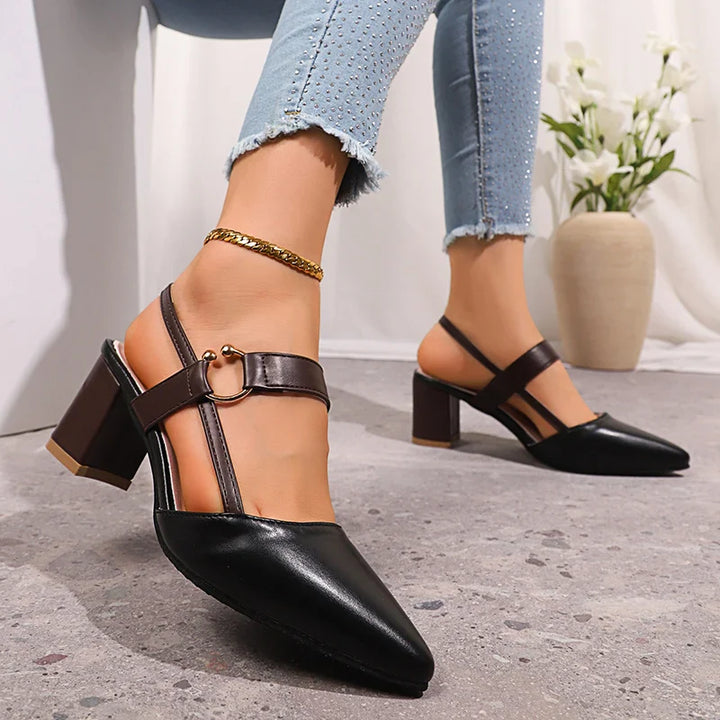 Golden ring adorned black leather block heels for women, providing comfort and chic style.