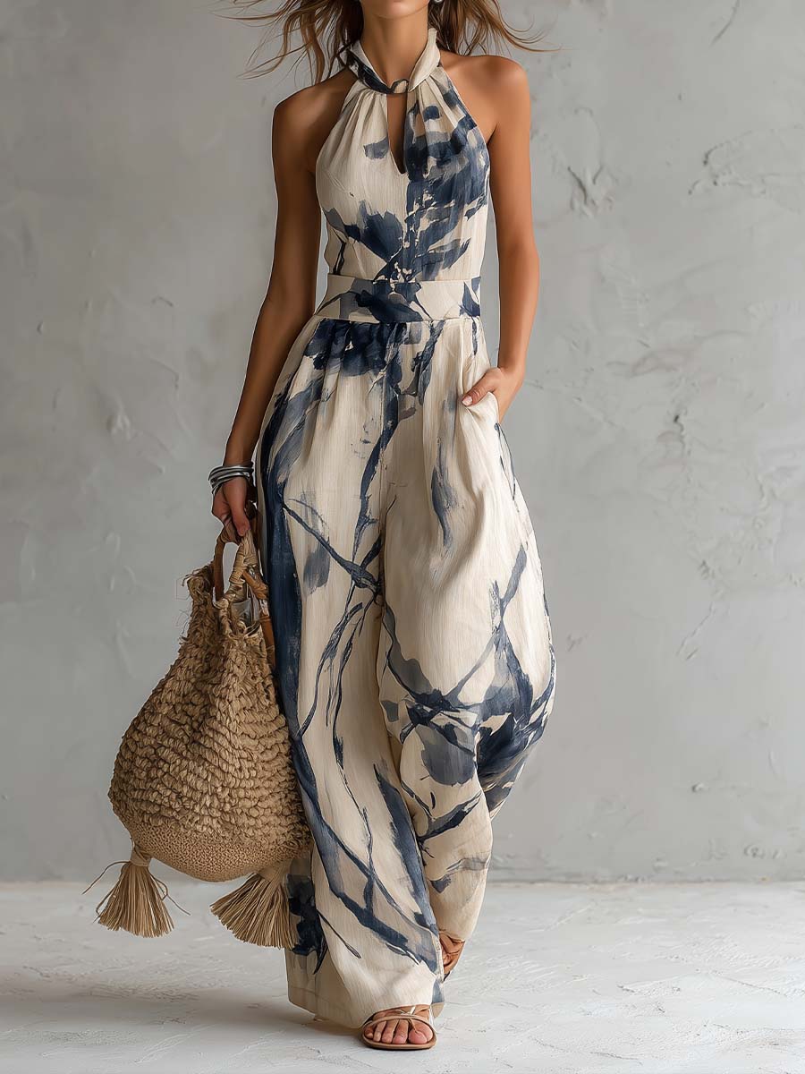 Women's halter neck wide leg jumpsuit with pockets, featuring a unique abstract ink wash print. Elegant summer style.