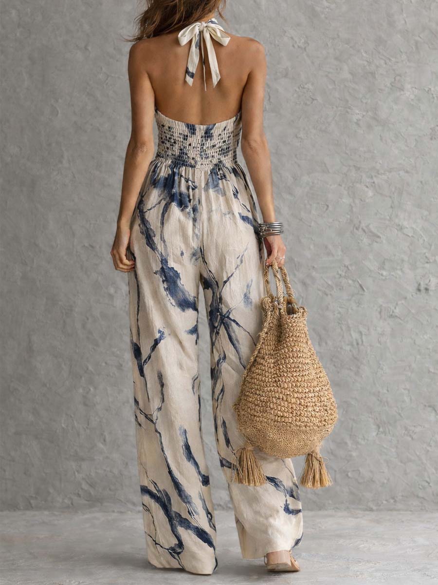 Chic women's halter neck wide leg jumpsuit with pockets. Comfortable abstract print for elegant casual spring/summer fashion.