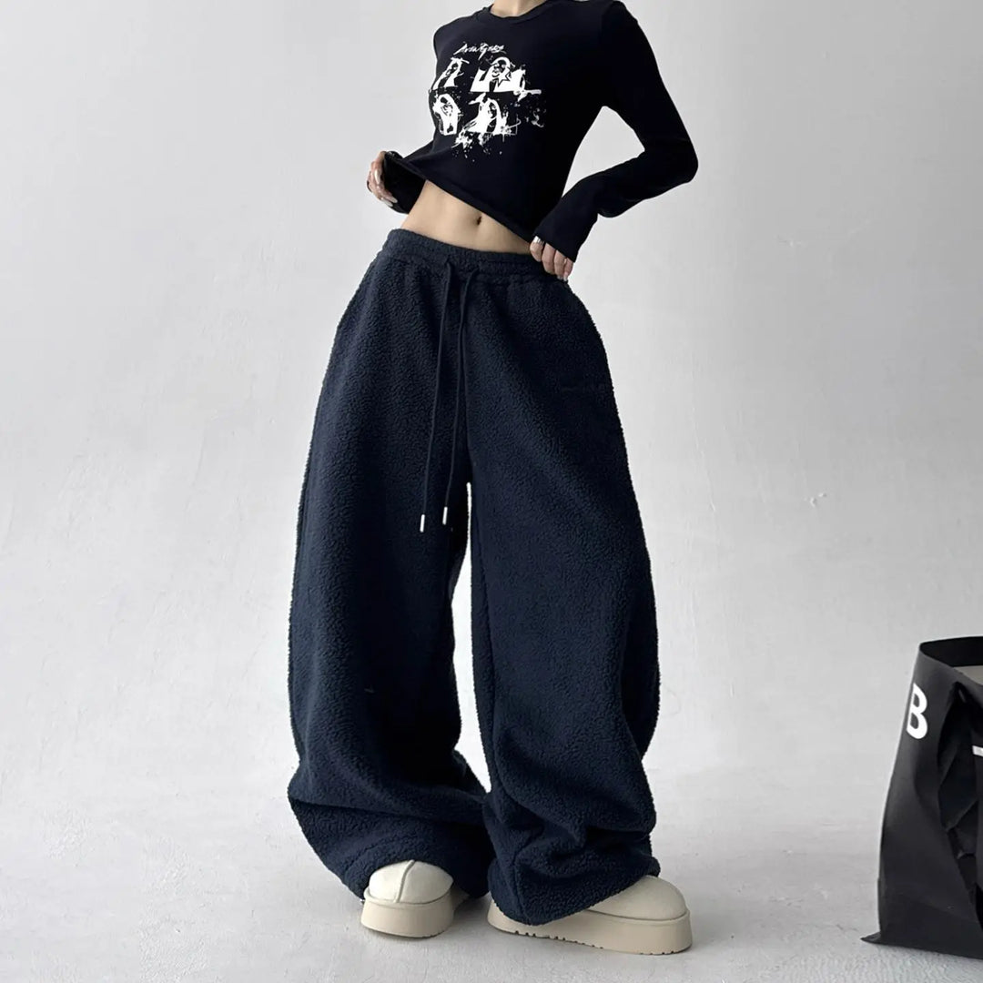 Folded warm fleece wide-leg lounge pants in a soft pink, perfect for cozy bottom wear