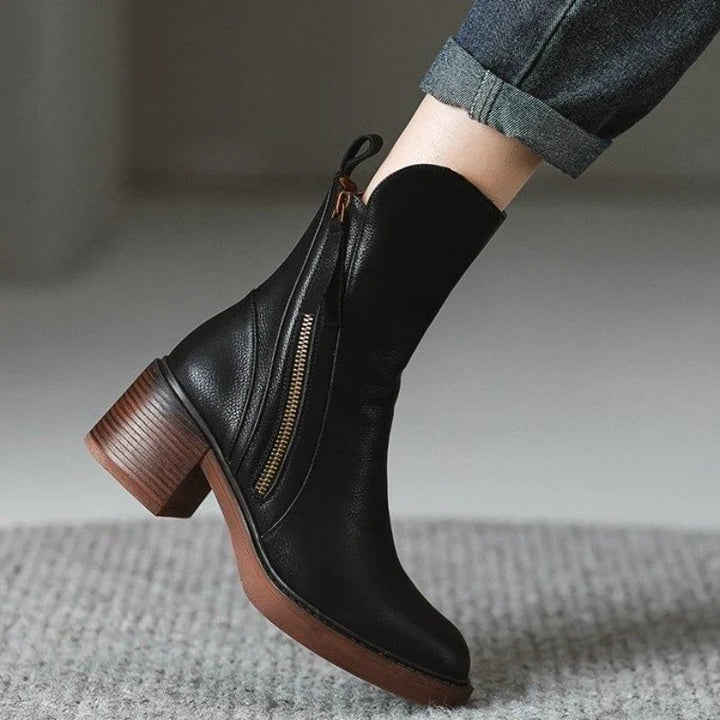 Stylish women's high heel boots; ankle length, zipper closure, and shock-absorbing sole.