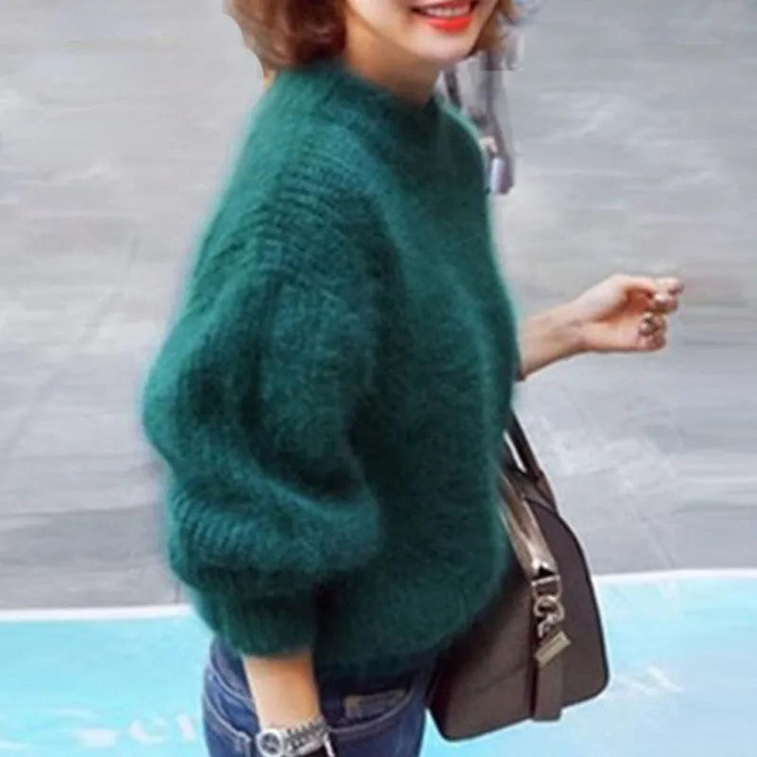 Textured image of a women's high neck knit pullover sweater, highlighting the quality knitwear.