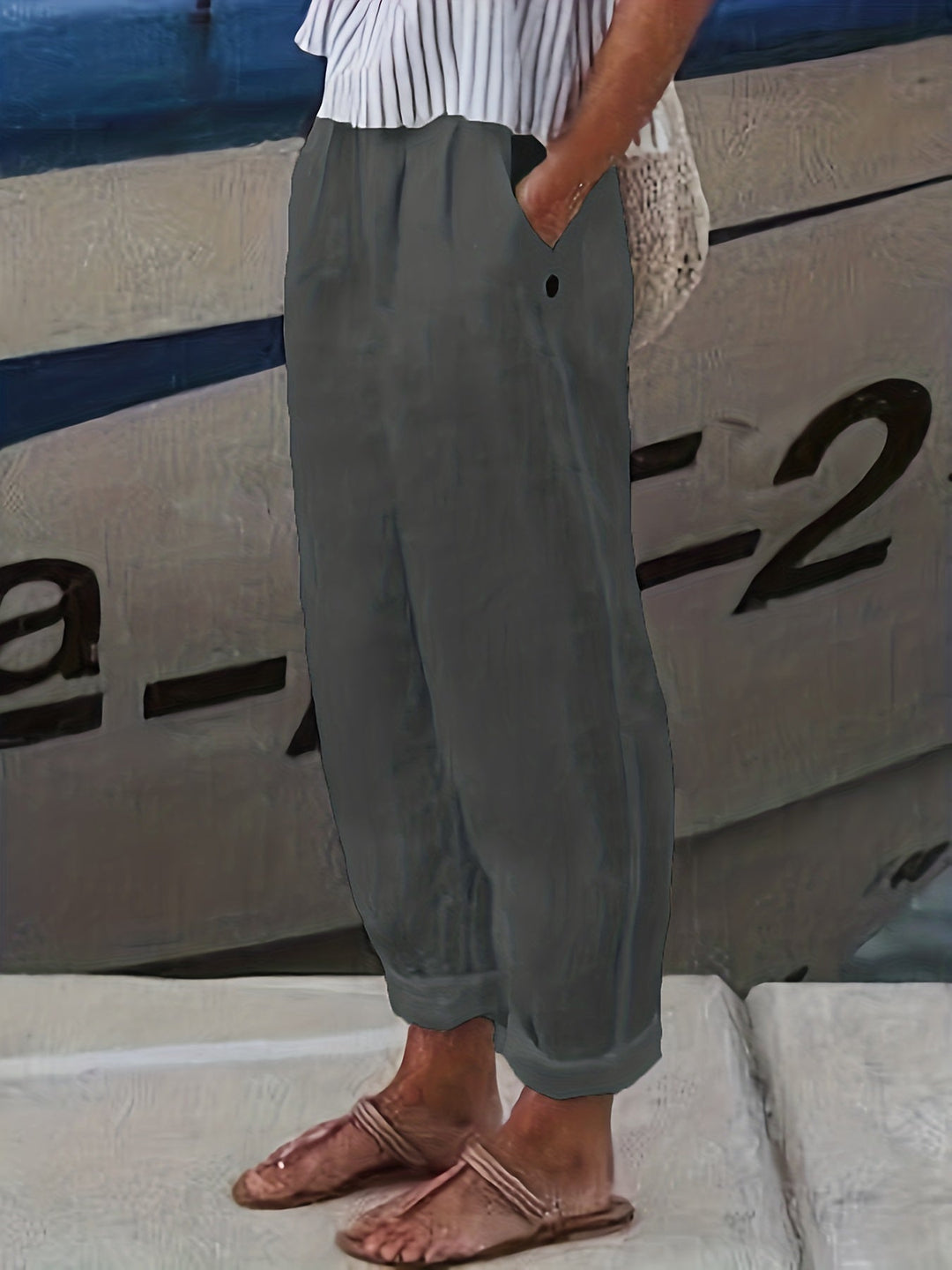 Women's vacation wear: high waist relaxed fit summer pants with chic roll hem detail.