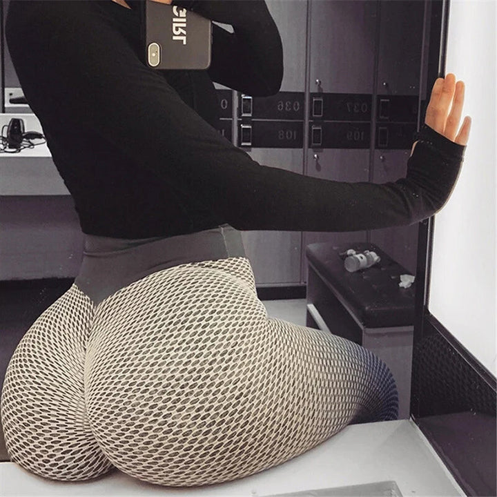 Close-up of the scrunch butt lifting detail on black high-waist women's athletic leggings
