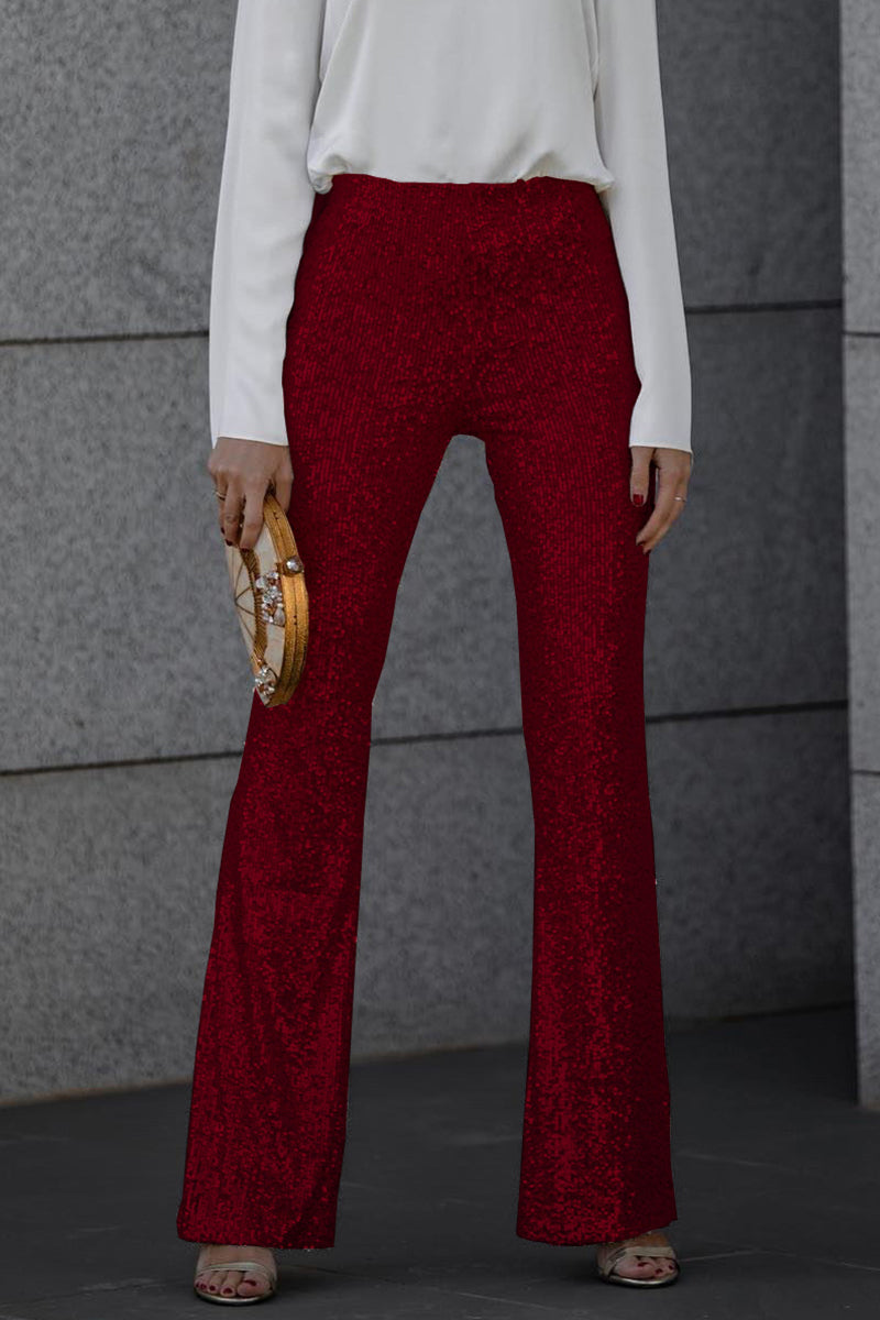 Close-up of women's sequin flared party trousers, highlighting the intricate sequin detail
