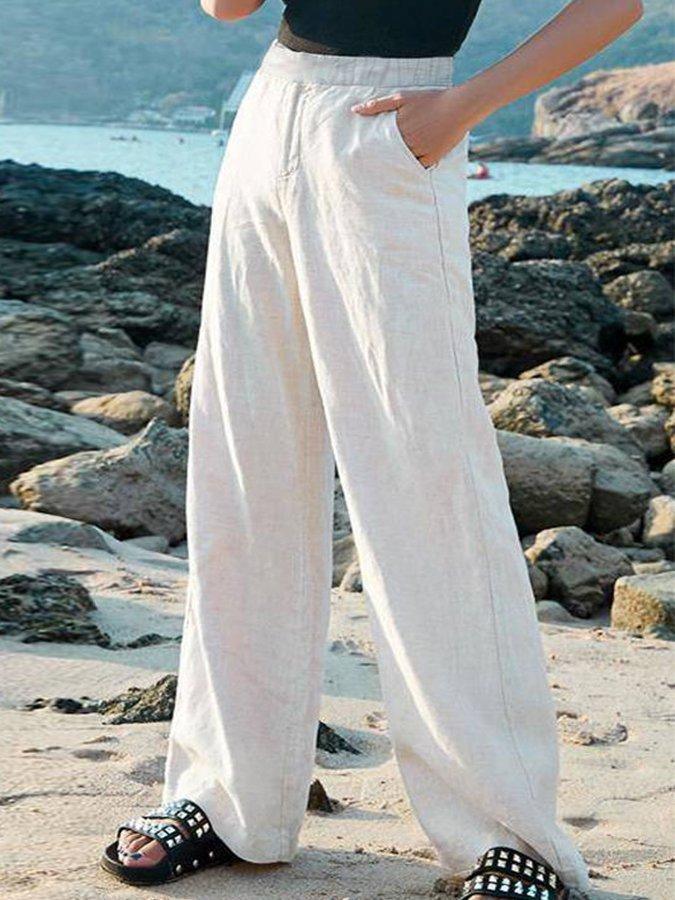 Chic women's high-waisted wide-leg flowy pants, ideal for a relaxed vacation outfit or beachwear.
