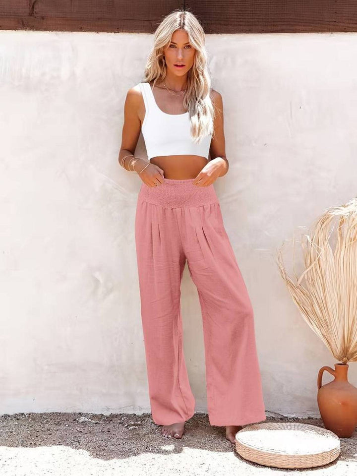 Summer women's wide leg pants with high smocked waist, lightweight and breathable fabric.