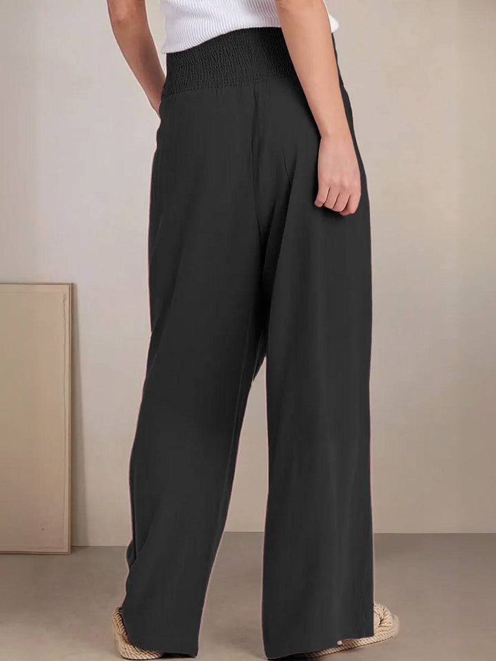 Relaxed fit women's high waist wide leg trousers, smocked waist detail for added style.