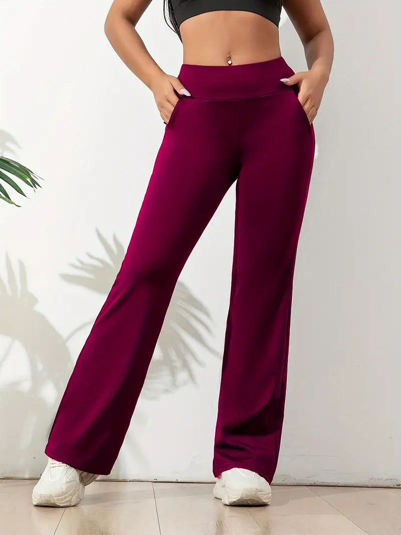 Stylish gray high-waisted flared athletic pants for women, featuring a stretch fit for yoga & active comfort.
